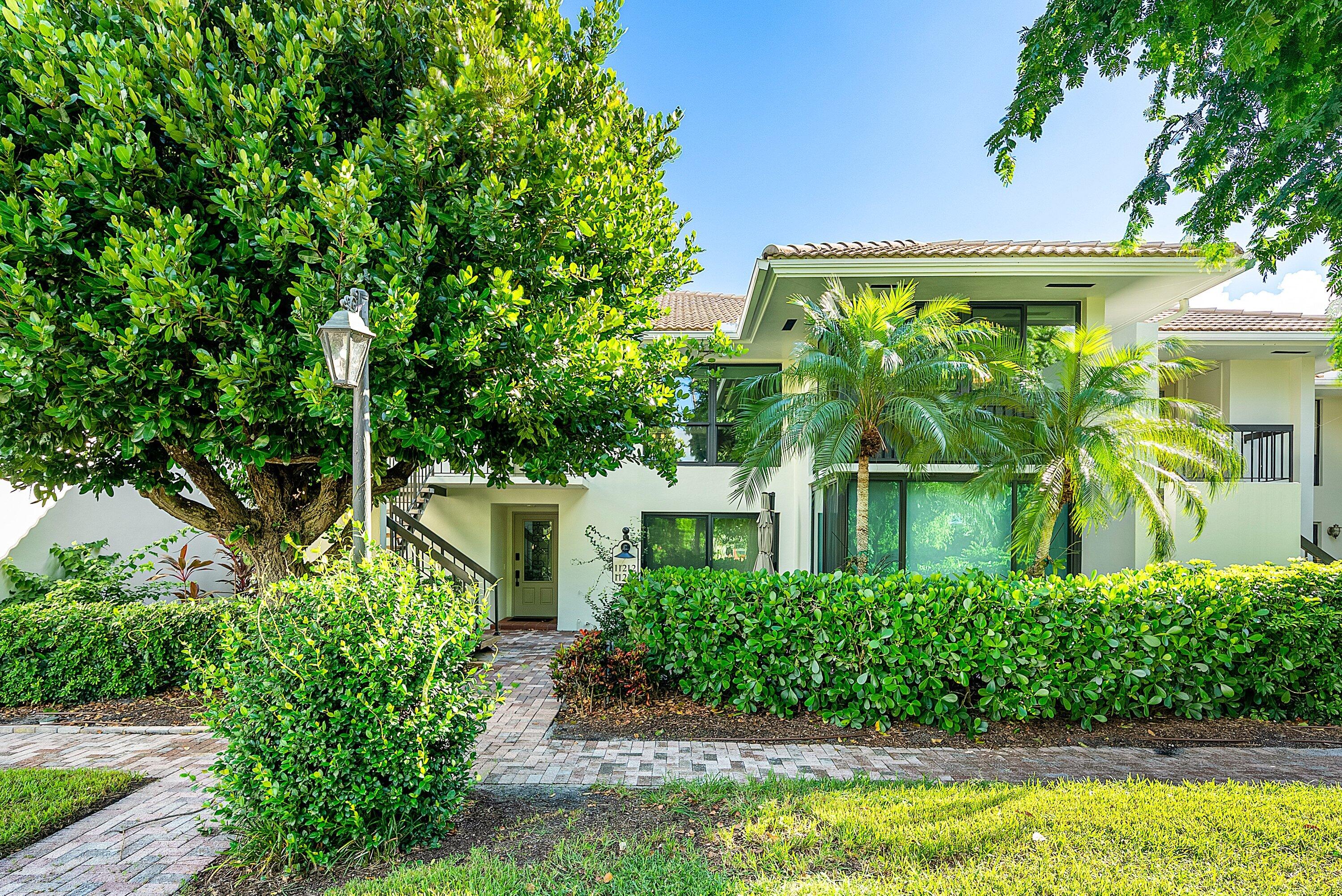 11212 Quail Covey Road, Unit GREEN HERON N Boynton Beach, FL 33436 - Photo 1 of 55 a front view of a house with garden