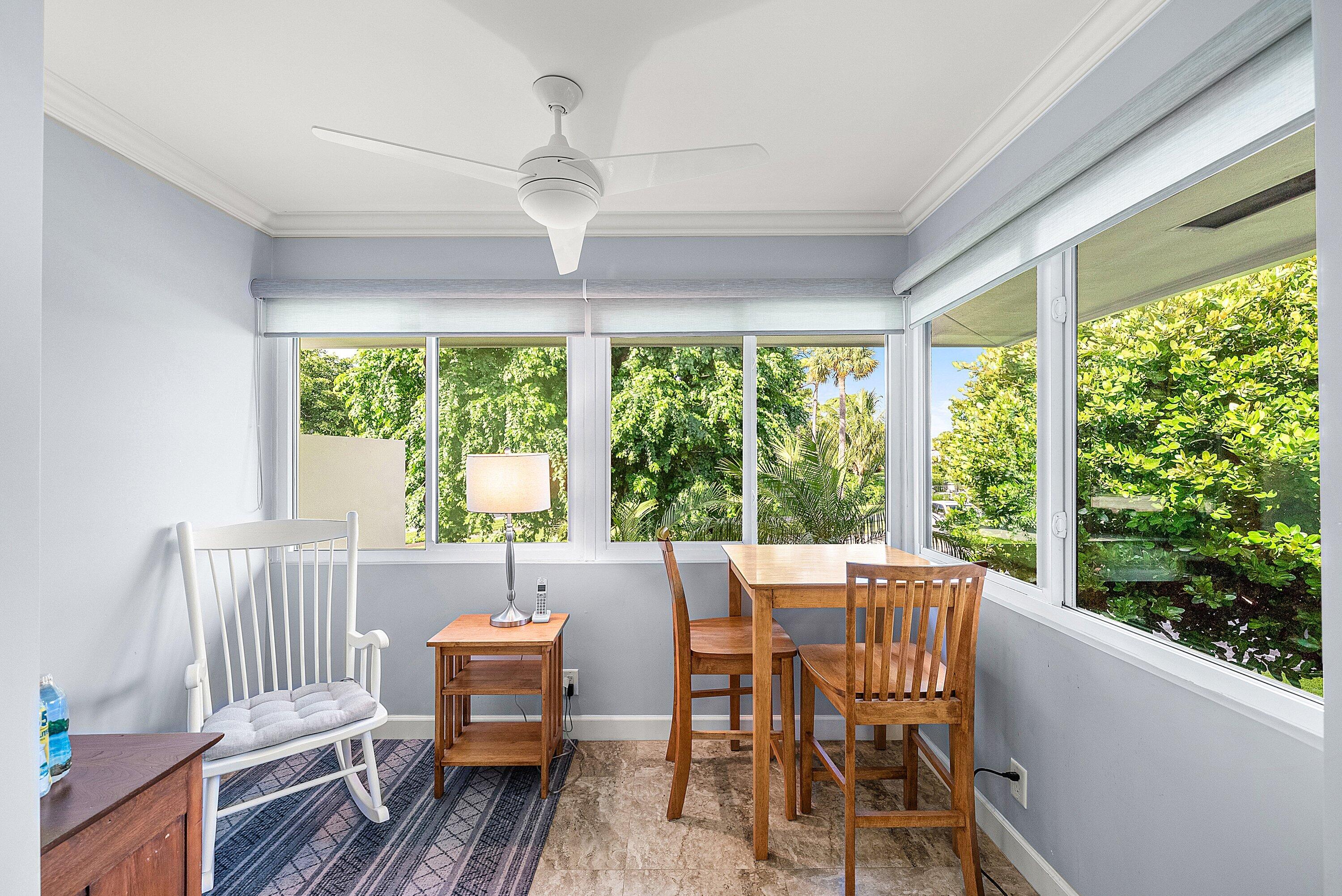 11212 Quail Covey Road, Unit GREEN HERON N Boynton Beach, FL 33436 - Photo 12 of 55 a view of a dining room with furniture large windows and wooden floor
