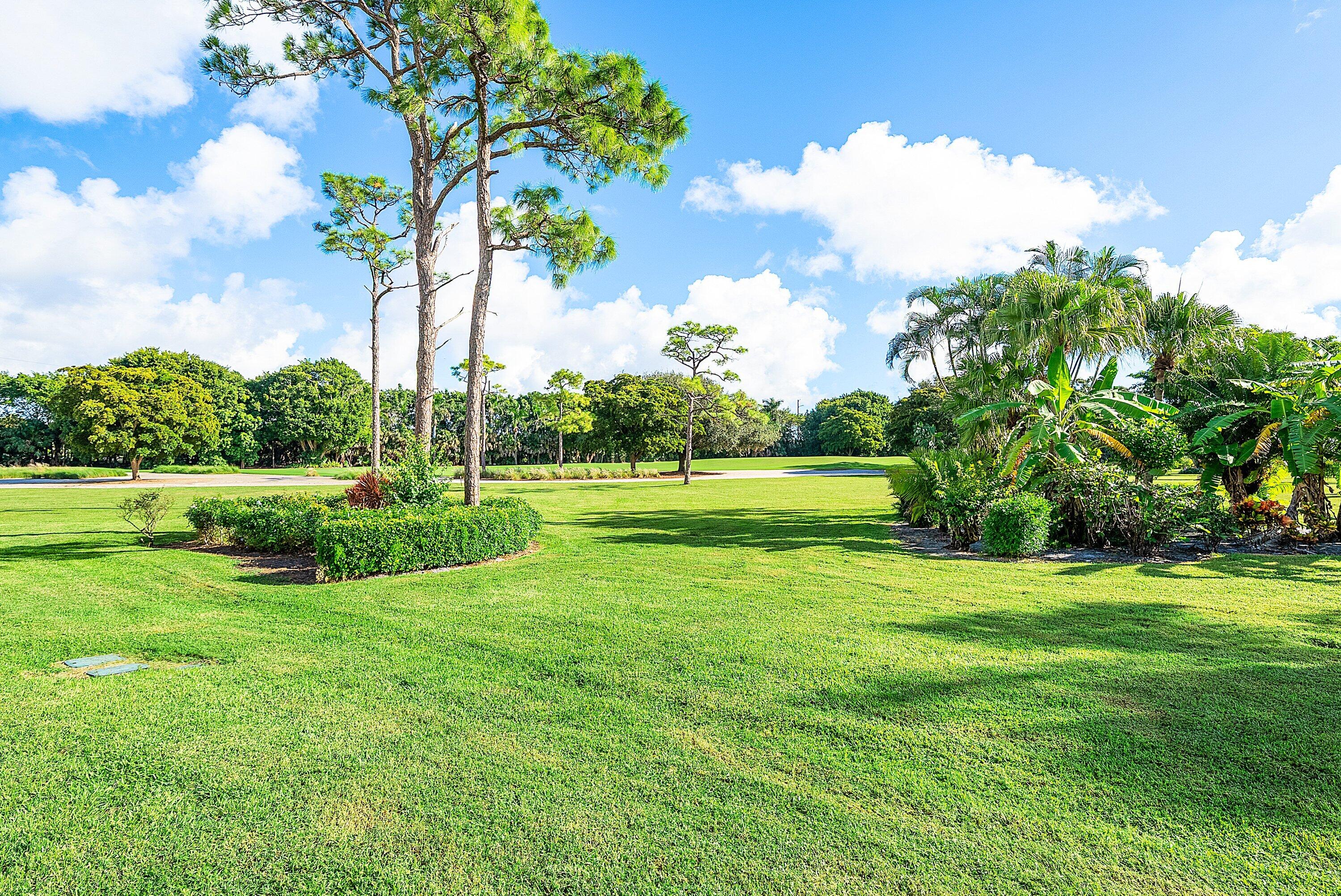11212 Quail Covey Road, Unit GREEN HERON N Boynton Beach, FL 33436 - Photo 30 of 55 a view of a park with large trees