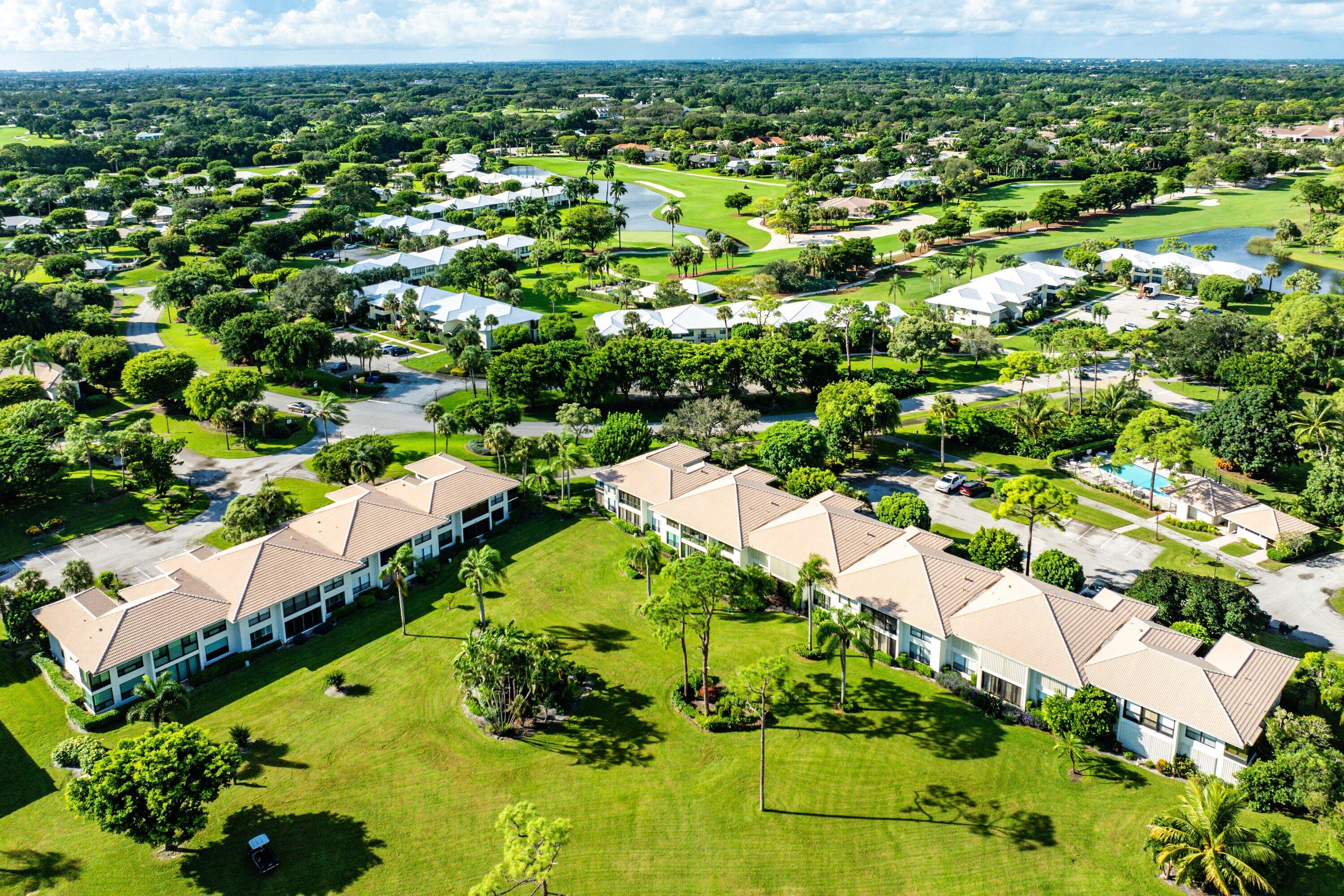 11212 Quail Covey Road, Unit GREEN HERON N Boynton Beach, FL 33436 - Photo 39 of 55 an aerial view of residential houses with outdoor space and trees
