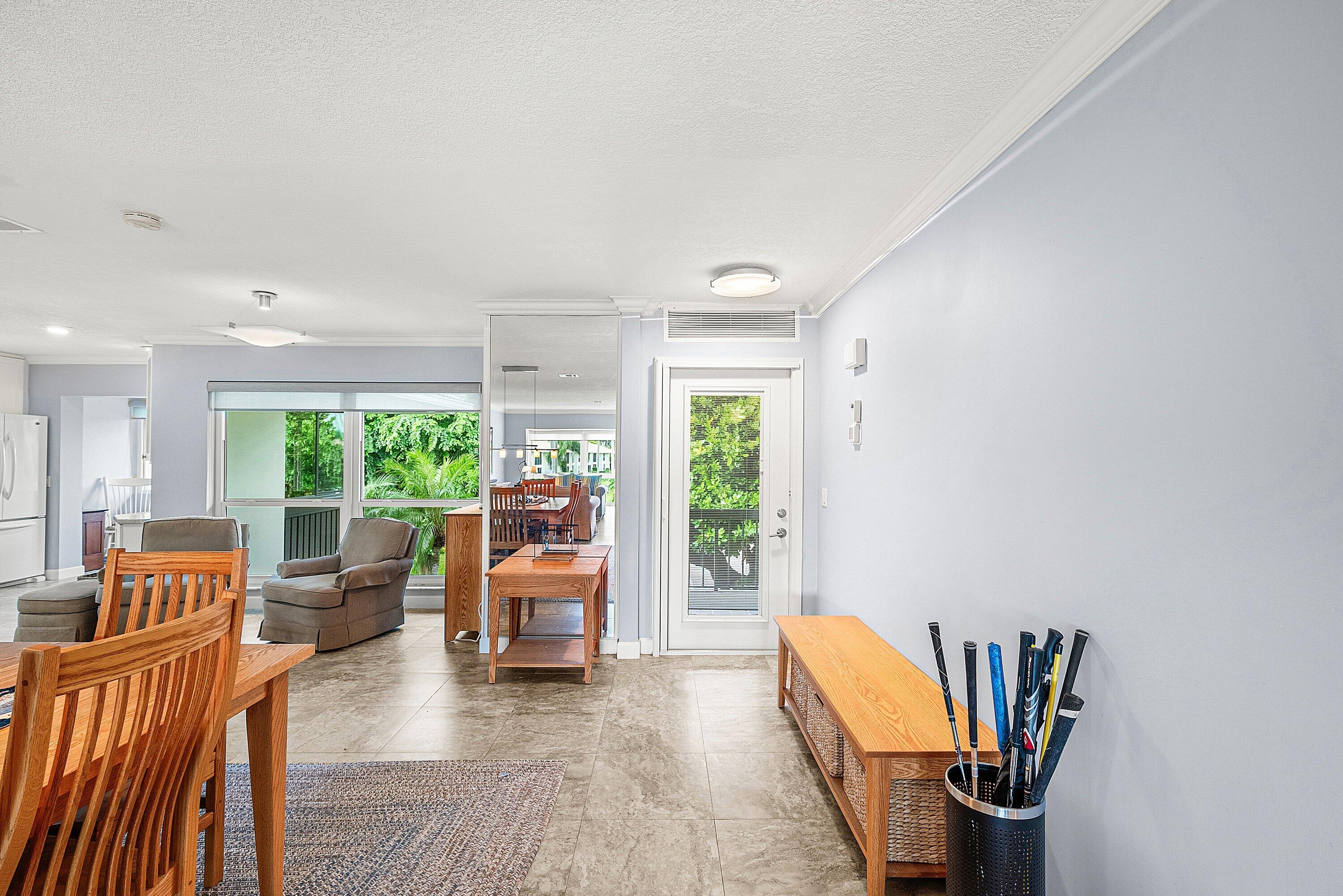 11212 Quail Covey Road, Unit GREEN HERON N Boynton Beach, FL 33436 - Photo 6 of 55 a living room with furniture a fireplace and a large window