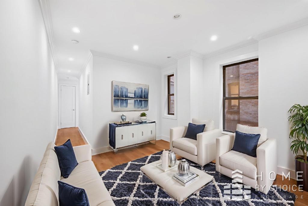 a living room with furniture a flat screen tv and rug