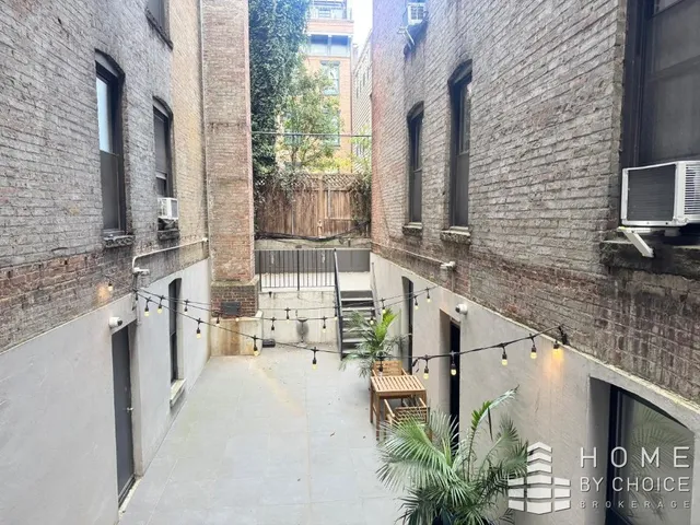 a view of living room with furniture and large window