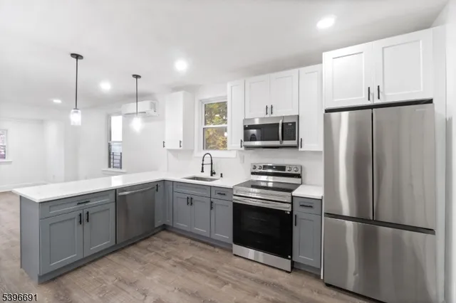 a kitchen with stainless steel appliances a refrigerator sink and microwave