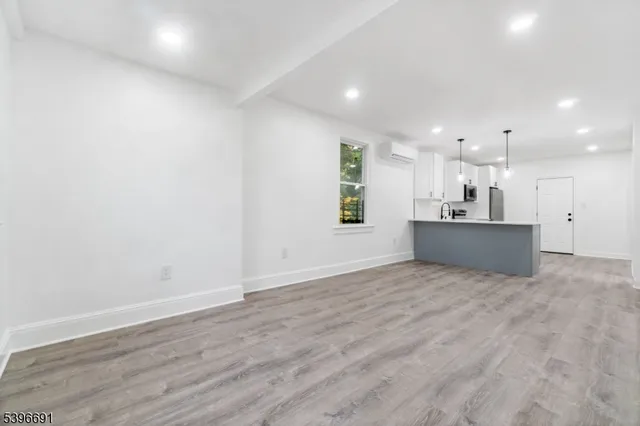 a view of a kitchen with a sink and a stove top oven