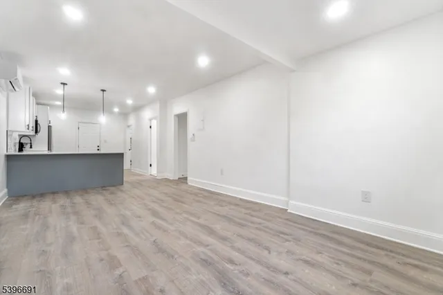 a view of a kitchen with a sink and a refrigerator