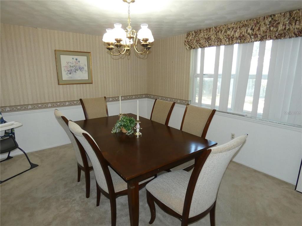 4392 Craftsbury Drive New Port Richey, FL 34652 - Photo 13 of 41 a view of a dining room with furniture and window