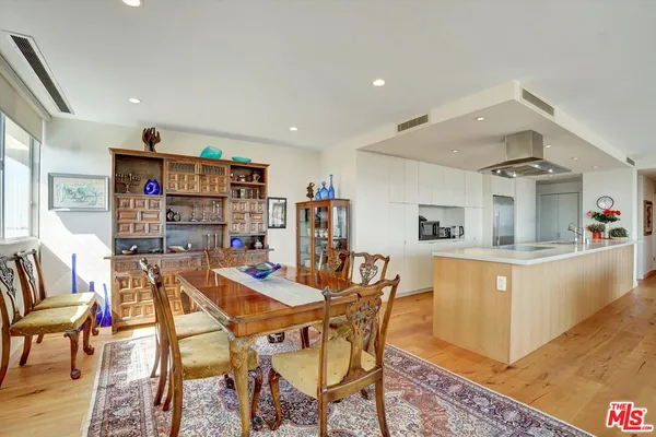 a living room with furniture a dining table and chairs with wooden floor