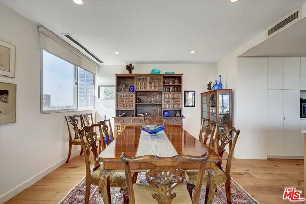 a living room with furniture a flat screen tv and a large window