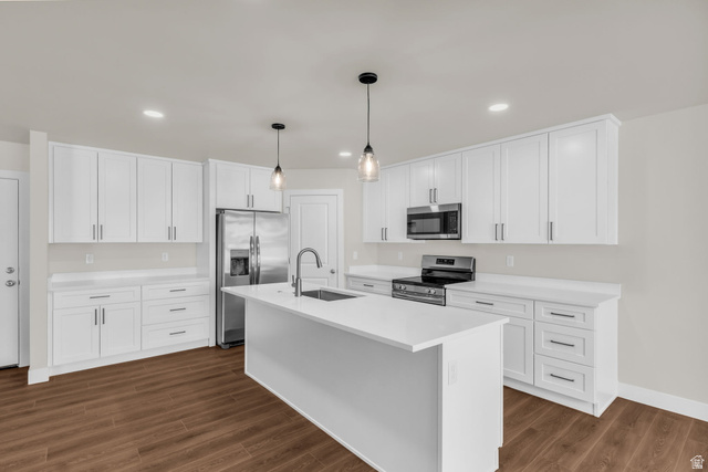 576 7th Avenue Midvale, UT 84047 - Photo 8 of 32 Kitchen featuring stainless steel appliances, a kitchen island with sink, hanging light fixtures, white cabinets, and dark wood-style flooring