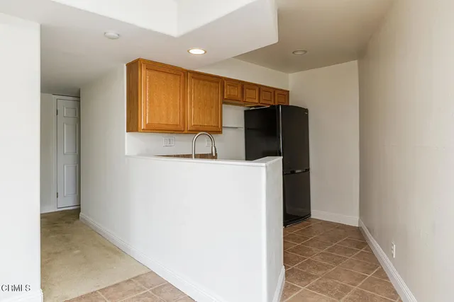 a kitchen with a refrigerator and a sink
