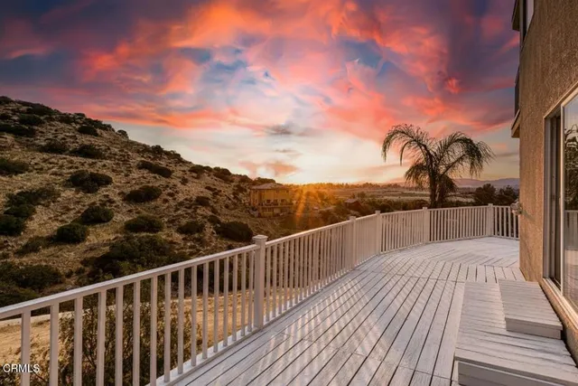 a view of a balcony with wooden floor