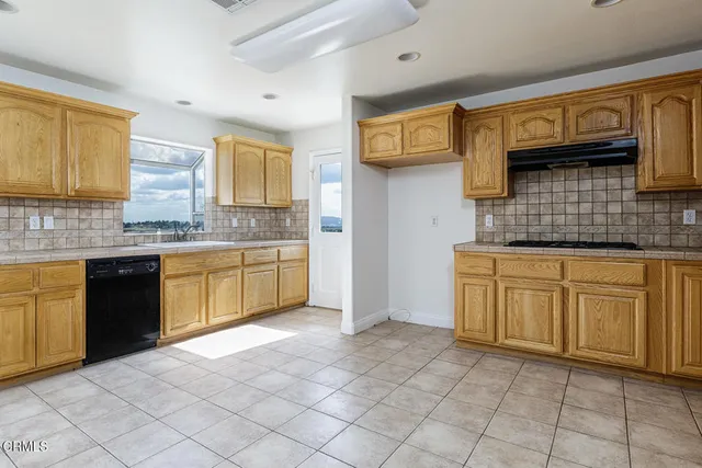 a kitchen with stainless steel appliances granite countertop a sink and cabinets