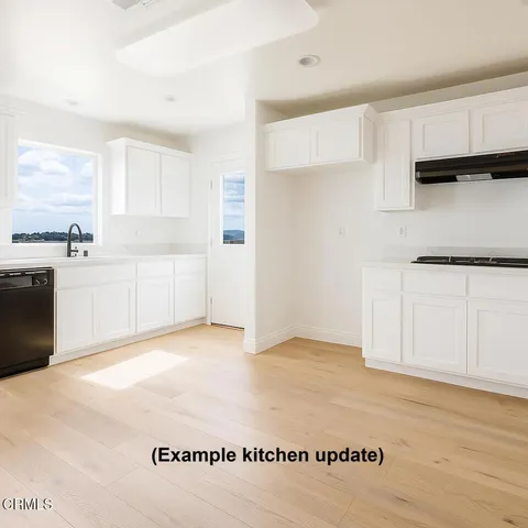 a view of a kitchen with electric appliances