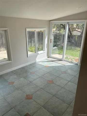a view of an empty room with glass door and glass door