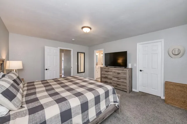 a bedroom with a bed and a flat screen tv