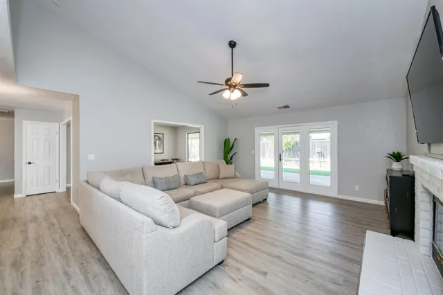 a living room with couches and a flat screen tv