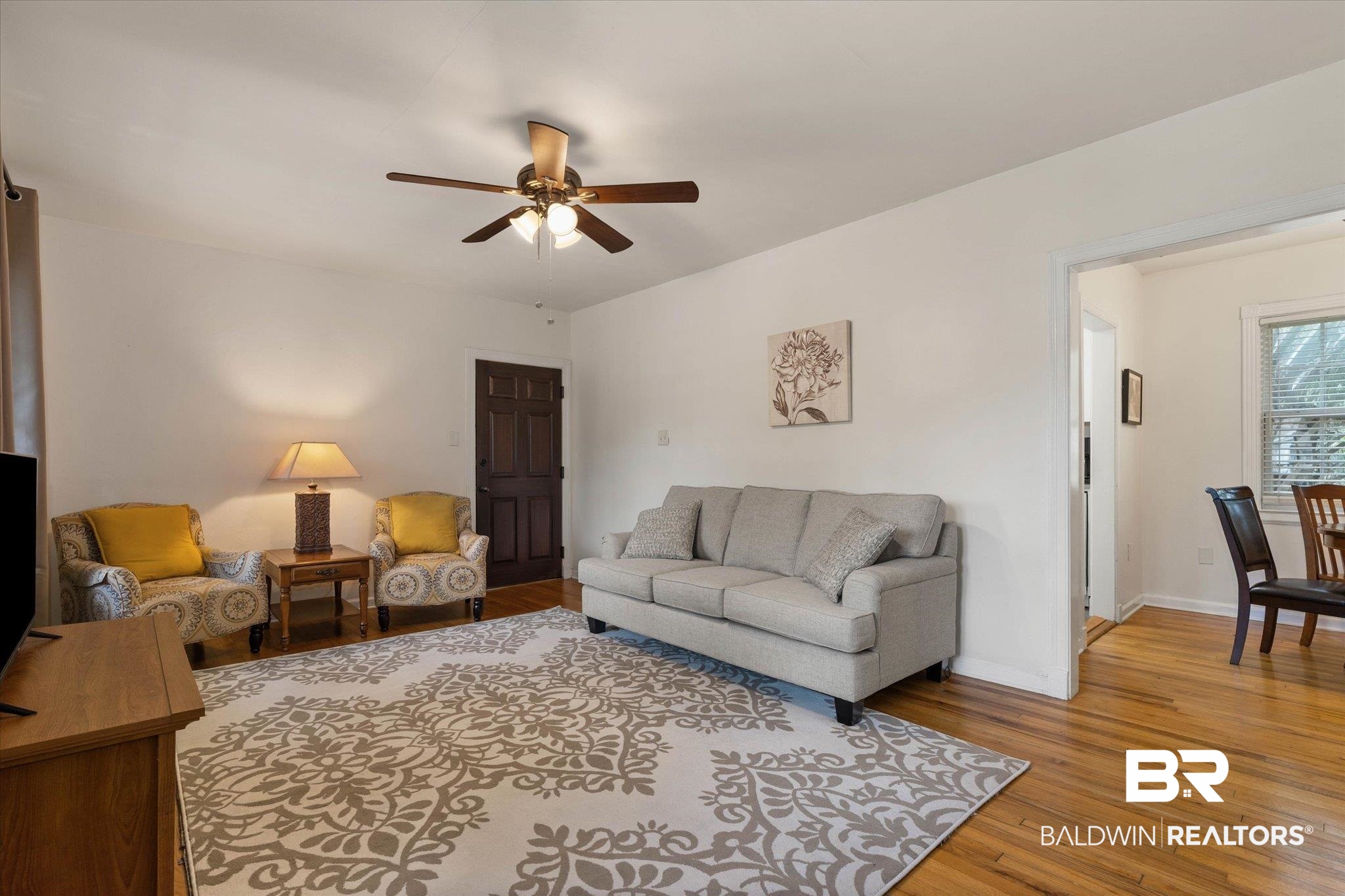 214 Upham Street, Unit 18C Mobile, AL 36607 - Photo 9 of 35 Living room featuring ceiling fan, light wood finished floors, and baseboards