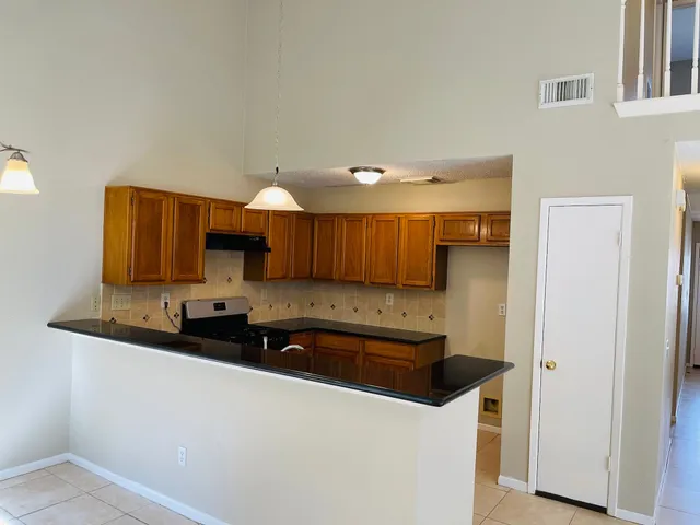 a kitchen with stainless steel appliances a sink stove and cabinets