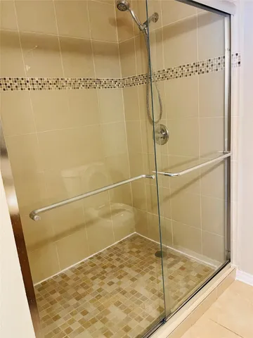 a bathroom with a glass shower door