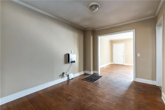 a view of a livingroom with a chair and a large mirror