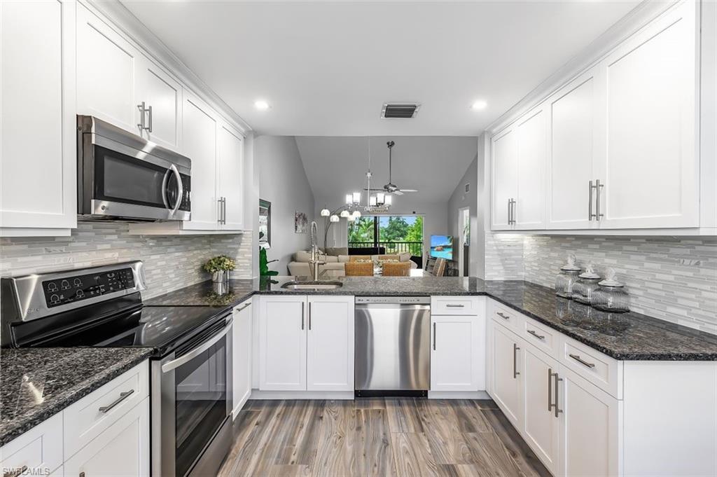 5695 Rattlesnake Hammock Road, Unit 202B Naples, FL 34113 - Photo 1 of 19 a kitchen with a sink stove and microwave