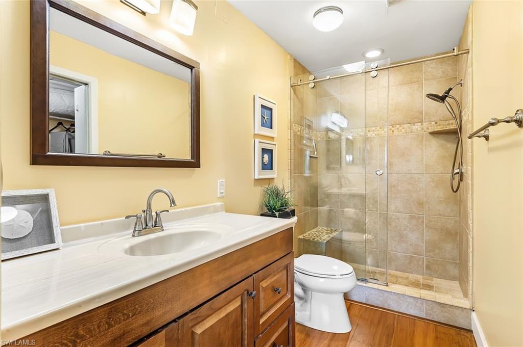 5695 Rattlesnake Hammock Road, Unit 202B Naples, FL 34113 - Photo 14 of 19 a bathroom with a sink a toilet and shower