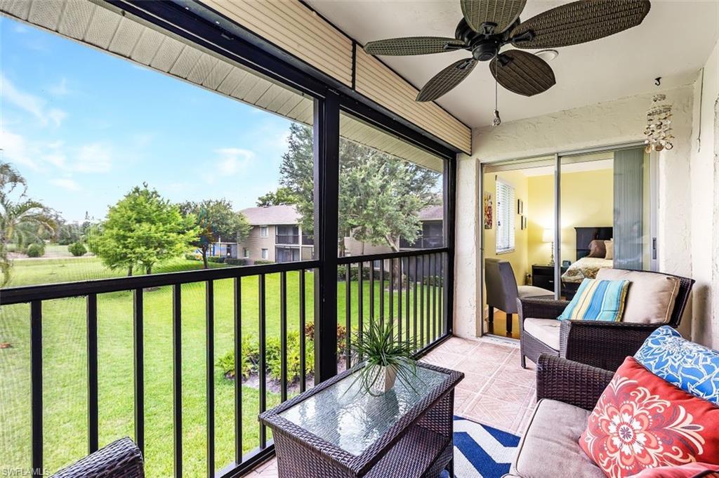5695 Rattlesnake Hammock Road, Unit 202B Naples, FL 34113 - Photo 16 of 19 a living room with furniture and a large window