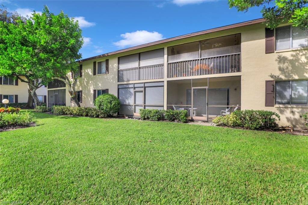 5695 Rattlesnake Hammock Road, Unit 202B Naples, FL 34113 - Photo 18 of 19 a view of a house with backyard and garden