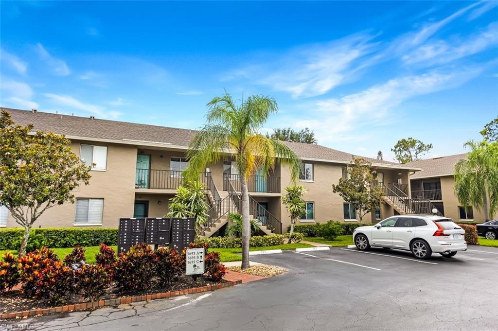 5695 Rattlesnake Hammock Road, Unit 202B Naples, FL 34113 - Photo 19 of 19 a view of car parked in front of house