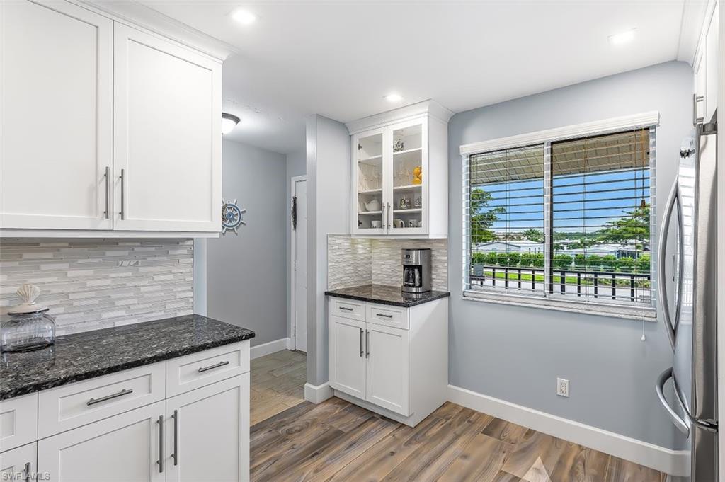 5695 Rattlesnake Hammock Road, Unit 202B Naples, FL 34113 - Photo 4 of 19 a kitchen with granite countertop a sink and cabinets