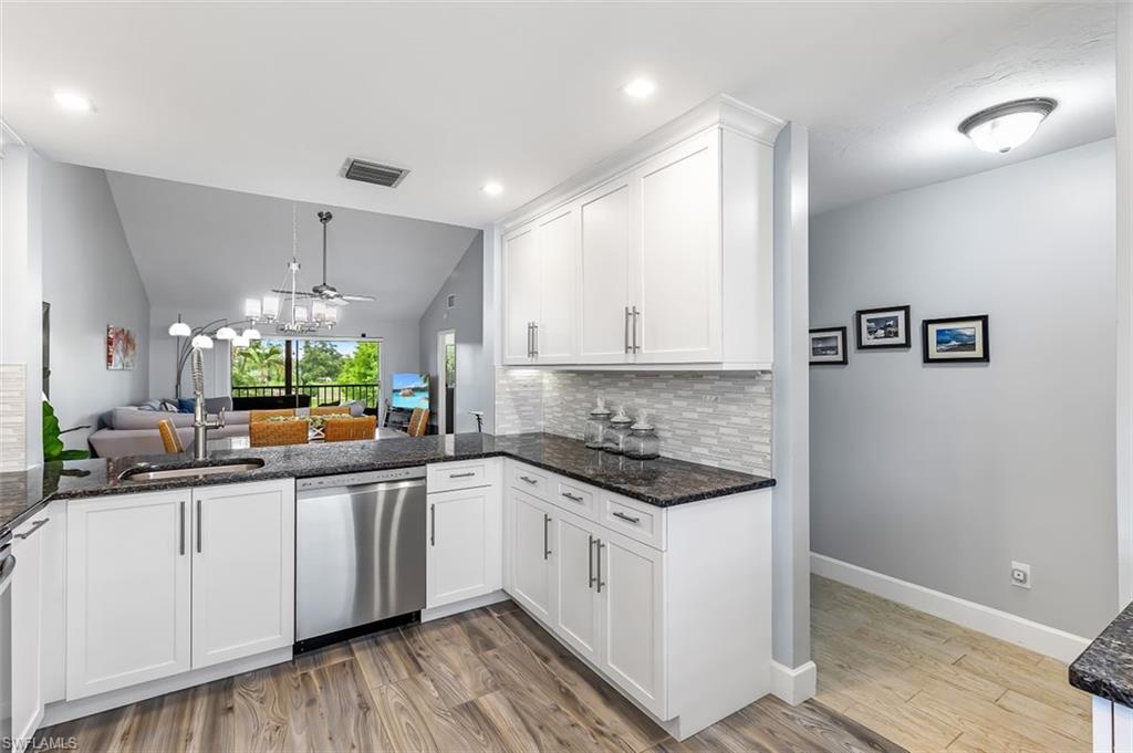 5695 Rattlesnake Hammock Road, Unit 202B Naples, FL 34113 - Photo 6 of 19 a kitchen with granite countertop a sink cabinets and window