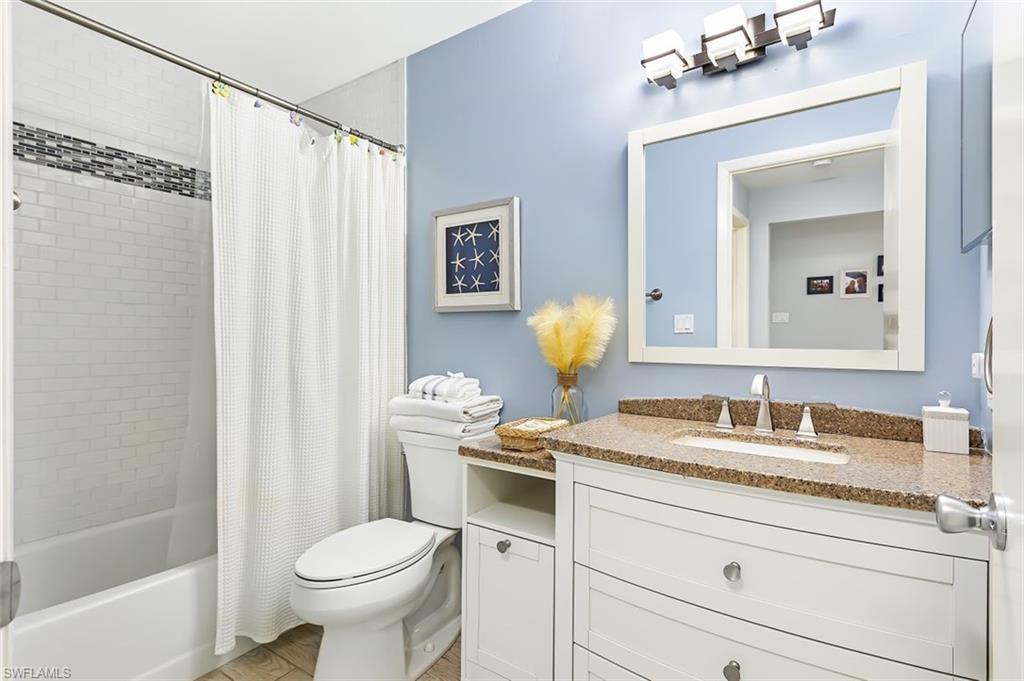 5695 Rattlesnake Hammock Road, Unit 202B Naples, FL 34113 - Photo 8 of 19 a bathroom with a granite countertop sink toilet and shower
