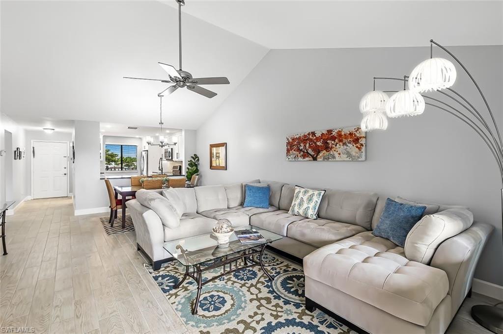 5695 Rattlesnake Hammock Road, Unit 202B Naples, FL 34113 - Photo 9 of 19 a living room with furniture chandelier and a chandelier