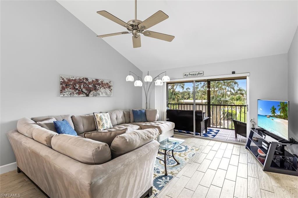 5695 Rattlesnake Hammock Road, Unit 202B Naples, FL 34113 - Photo 10 of 19 a living room with furniture large window with a flat screen tv