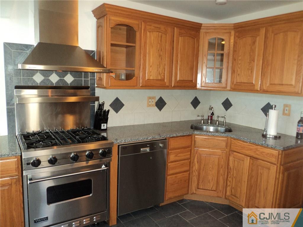 20 Brookville Road Edison, NJ 08817 - Photo 3 of 13 a kitchen with stainless steel appliances granite countertop a stove and a sink
