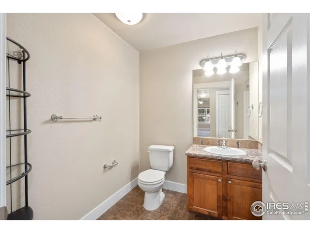 a view of a house with a yard and large tree