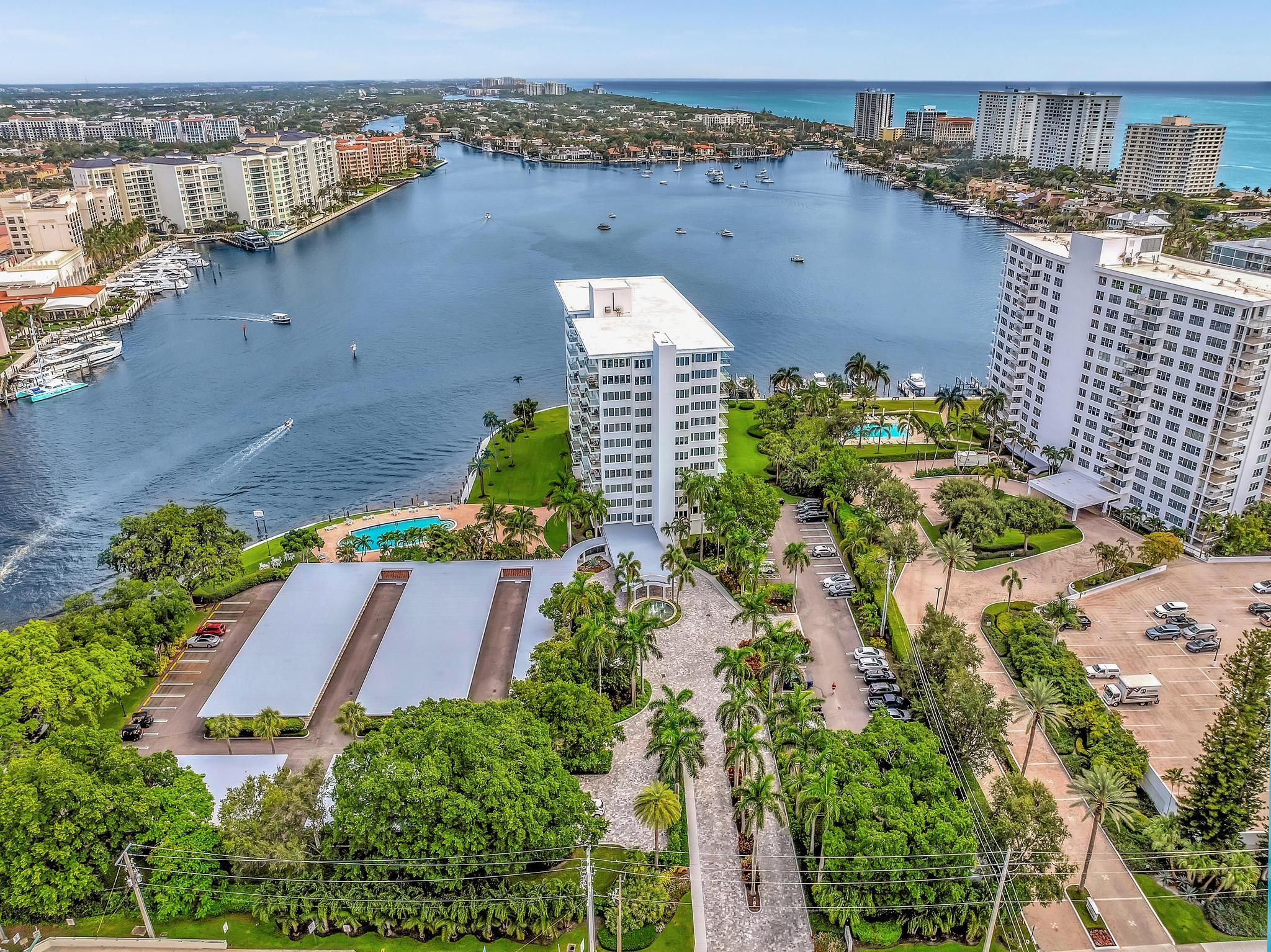 701 East Camino Real, Unit 12G Boca Raton, FL 33432 - Photo 63 of 82 an aerial view of a house with a yard and lake view