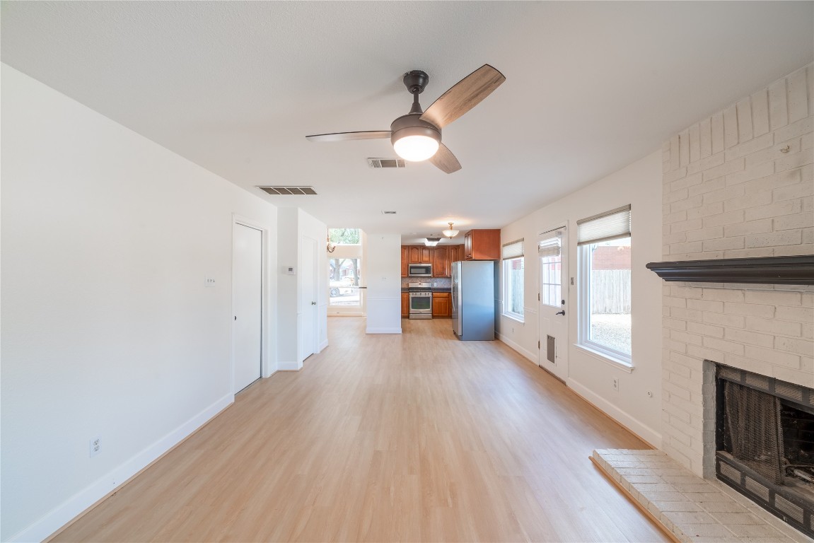 1201 Deer Grove Drive Cedar Park, TX 78613 - Photo 14 of 35 a view of a big room with wooden floor a fireplace and windows