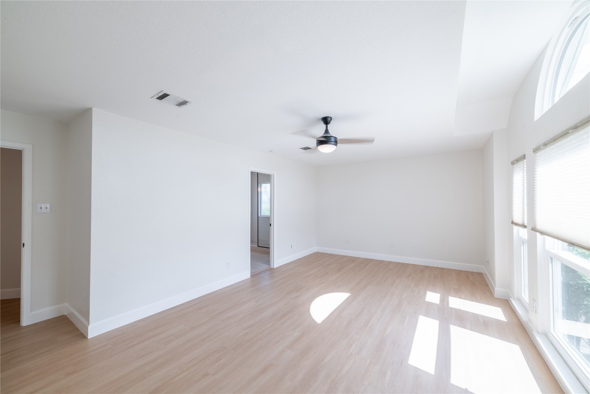1201 Deer Grove Drive Cedar Park, TX 78613 - Photo 16 of 35 an empty room with wooden floor fan and windows
