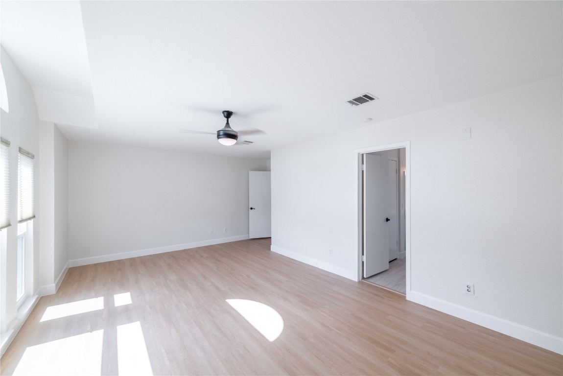 1201 Deer Grove Drive Cedar Park, TX 78613 - Photo 17 of 35 a view of an empty room with wooden floor and a window