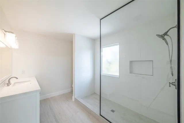 a bathroom with a sink and shower