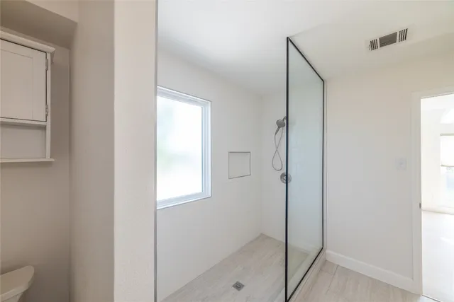 a bathroom with a shower and a toilet