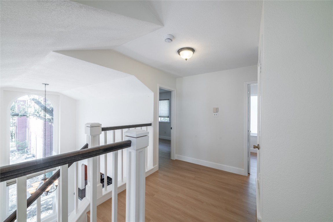 1201 Deer Grove Drive Cedar Park, TX 78613 - Photo 23 of 35 a view of a hallway with wooden floor and staircase