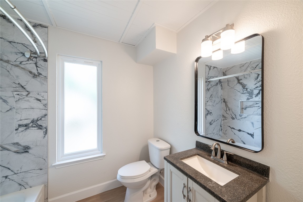1201 Deer Grove Drive Cedar Park, TX 78613 - Photo 28 of 35 a bathroom with a sink a toilet and a mirror