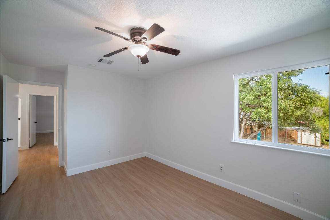 1201 Deer Grove Drive Cedar Park, TX 78613 - Photo 30 of 35 a view of an empty room with wooden floor and a window