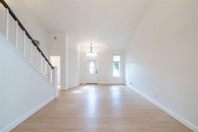 a view of a room with wooden floor and stairs
