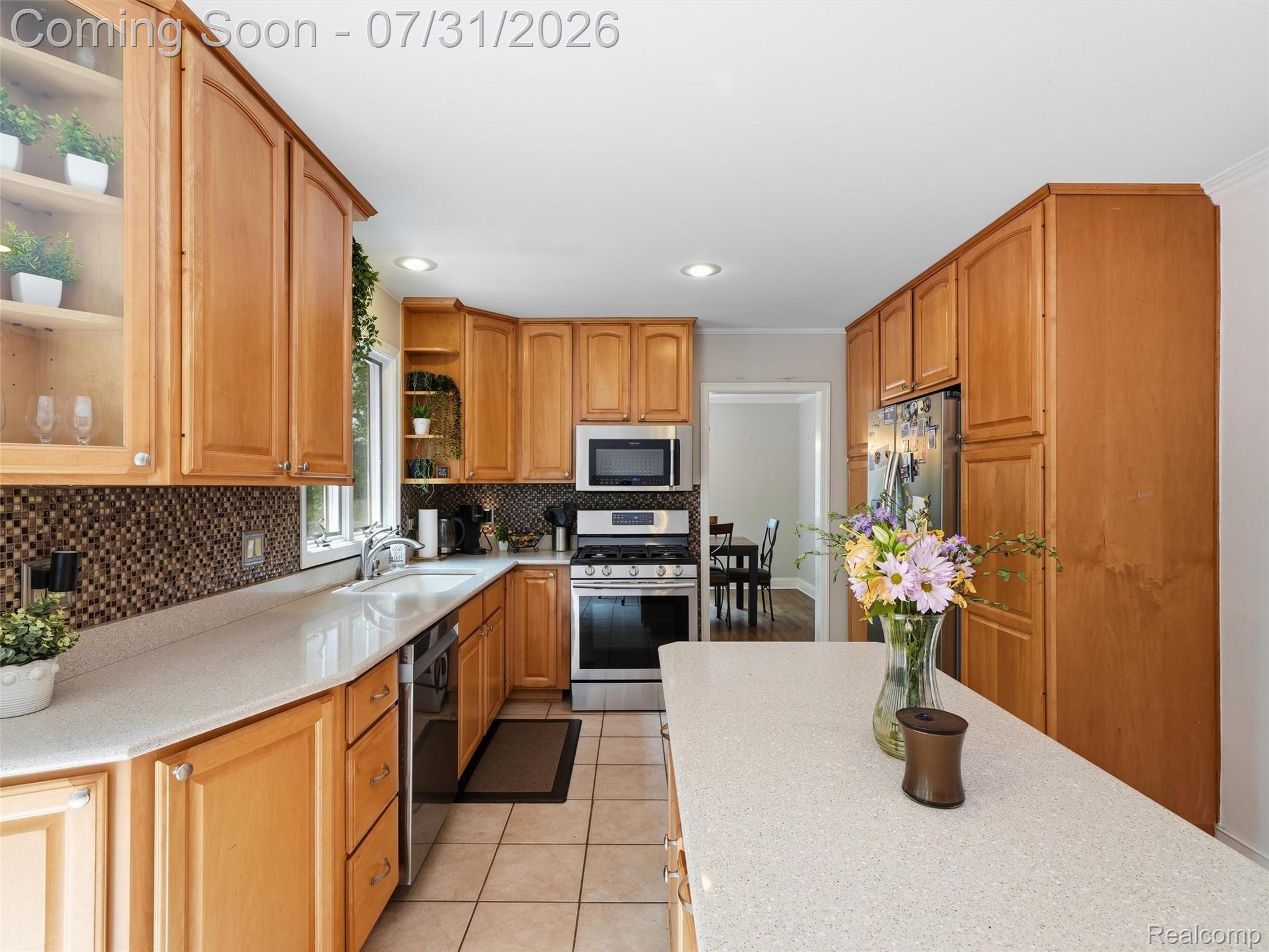 138 Aintree Road Rochester, MI 48306 - Photo 28 of 53 Kitchen featuring light wood cabinetry, light-colored countertops, and stainless steel appliances