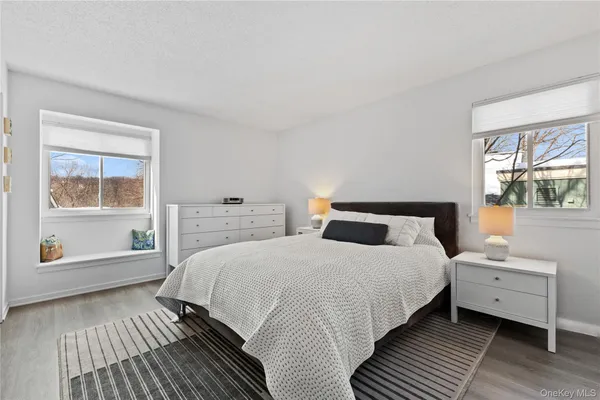 a bedroom with a bed and a large window