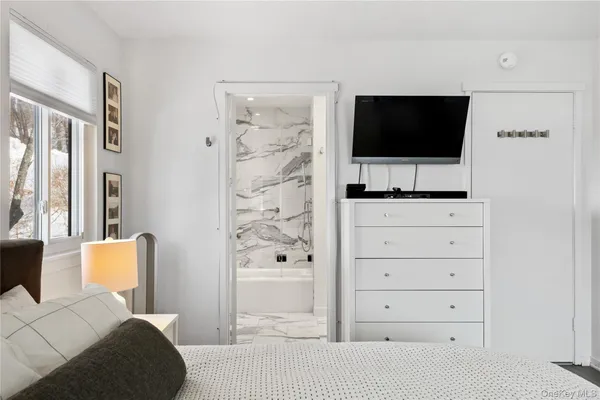 a living room with flat screen tv a lamp and a flat screen tv